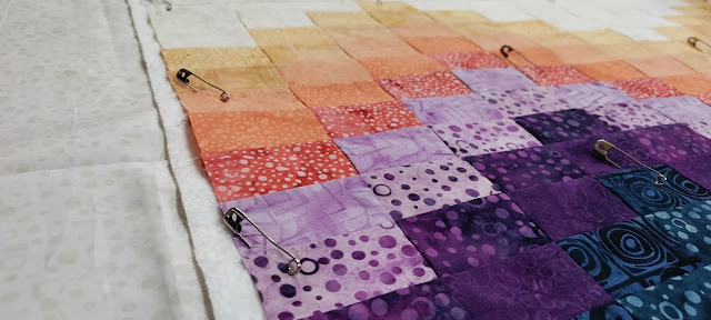 Pin basting my Ebb and Flow quilt made with Citified batik fabrics